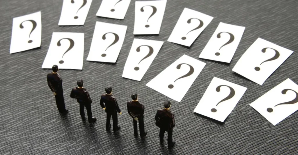 Figures standing in front of multiple question marks, representing the common doubts property owners face before making an investment decision