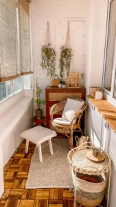 Terrace or gallery in a holiday rental with wicker furniture, plants and natural light creating a cosy and relaxing space